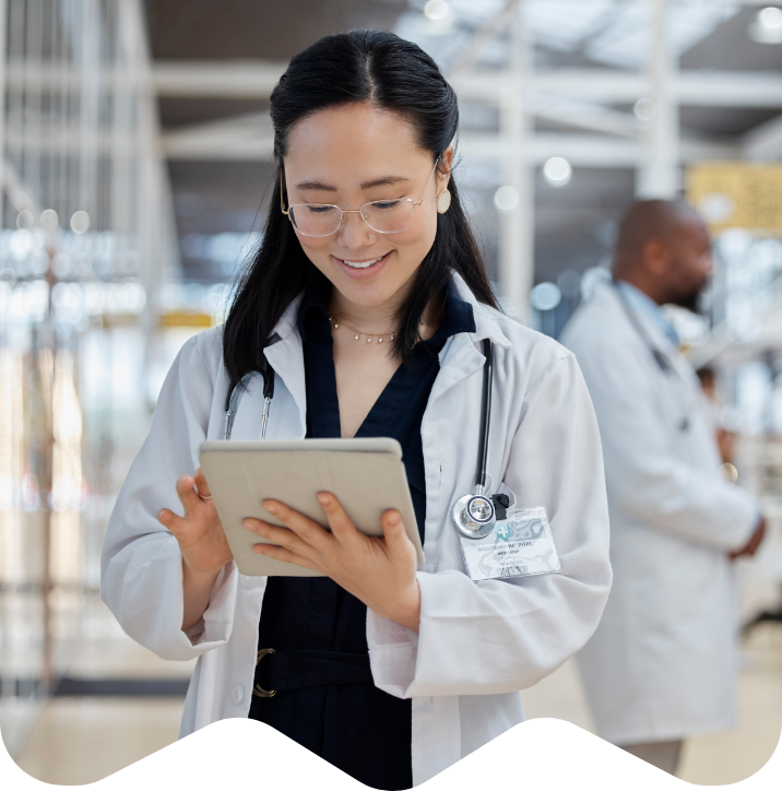 Doctor looking at resources on tablet