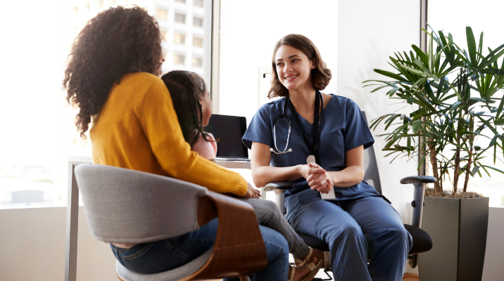 Doctor with patient and parent sitting