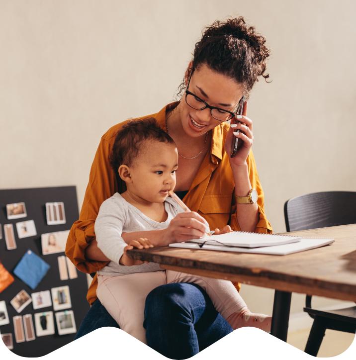 Parent holding child while on the phone