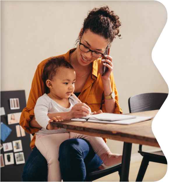 Parent holding child while on the phone